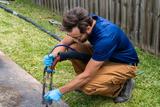 crew member lifting concrete with polyurethane injections