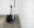 sump pump with a battery backup installed in a basement