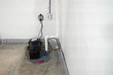 sump pump with a battery backup installed in a basement