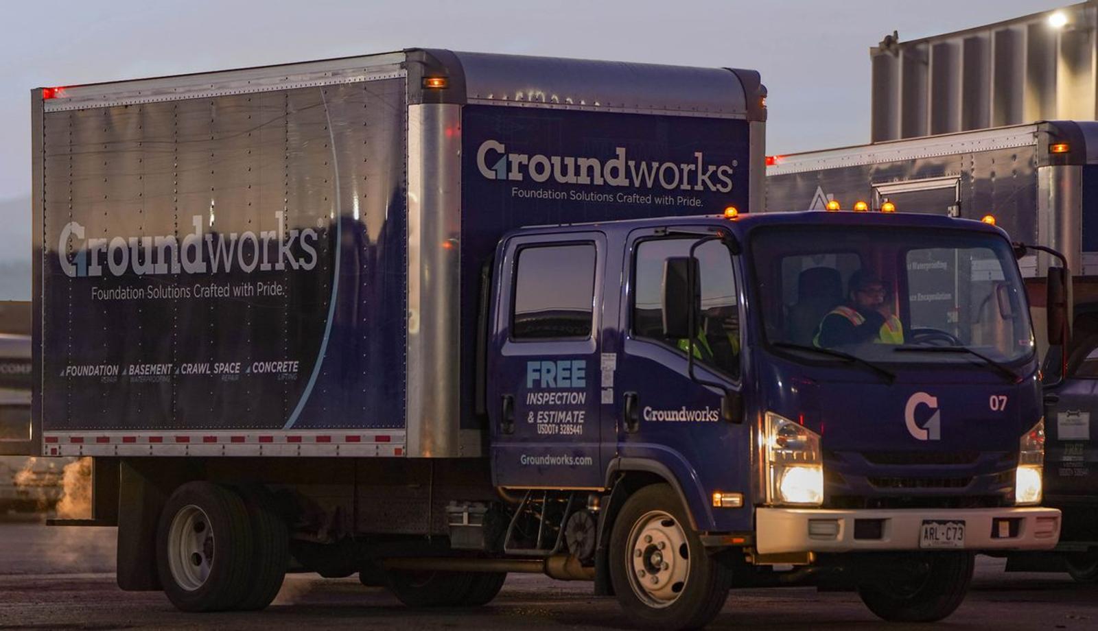 Truck with "Groundworks" branding parked at a depot, advertising free inspection and estimate services.