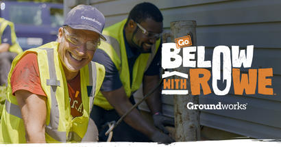 Two workers in safety vests smiling while working outside near a building. Text: "Go Below with Rowe, Groundworks and Mike Rowe.