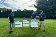 Groundworks staff pose with sponsor lawn signs