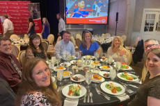 Groundworks staff sits at a dinner table.
