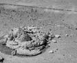 A pile of mudjacking material sits on a dry, sandy surface in black and white.