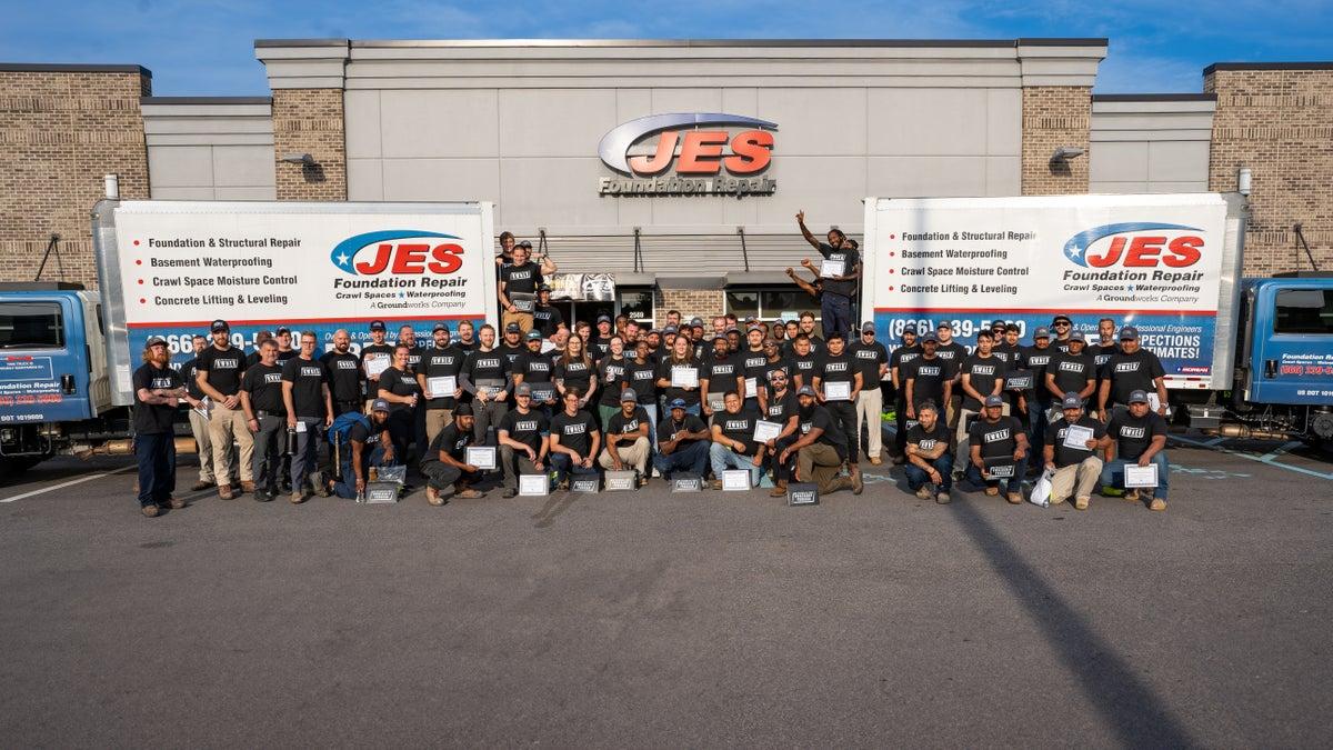 JES Team in front of trucks and building
