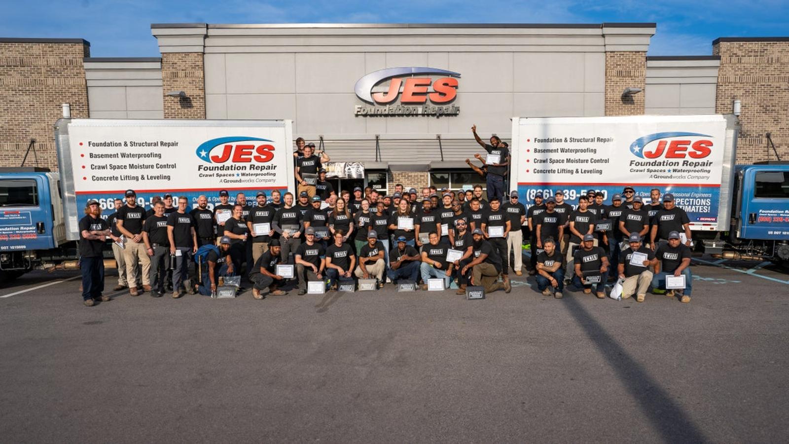 JES Team in front of trucks and building