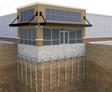Cross-section illustration of a building with commercial foundation underpinning, featuring deep piers anchored into the ground for stability.