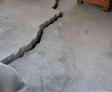 image of severe cracking in concrete floor creating trip hazard. How an Uneven Concrete Floor can Disrupt you Commercial Facility