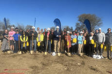 The Groundworks Tulsa team stands outside with their shovels to break ground for a new house.