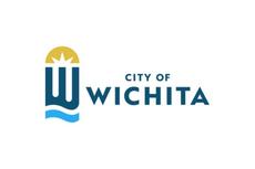 Wichita city logo with stylized "W" and sunburst design above, blue waves below, and text "City of Wichita.