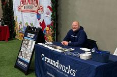 Groundworks Partners with Sussex County Miners for "Lights Show" man sitting at table at the event