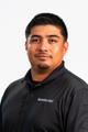 A man in a black "Groundworks" polo shirt poses against a white background.