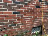stair-step cracks on exterior brick wall
