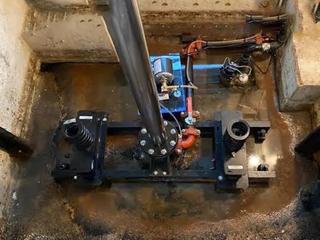 image of eleavtor pit with standing water before drain installation