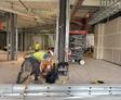 image of workers performing polyurethane injection underneath a column
