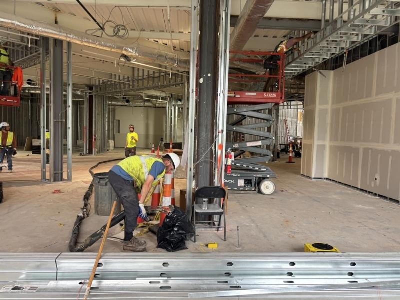 image of workers performing polyurethane injection underneath a column