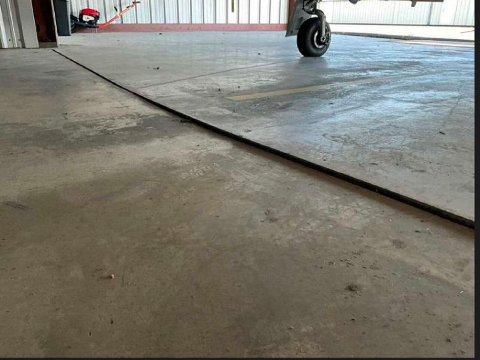 image of uneven concrete joints that are out of ADA Compliance at Storage Bay Slab Rehabilitation at Charlotte-Monroe Executive Airport