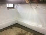 vapor barrier installed in basement with stone walls