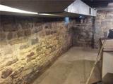 old home with a fieldstone foundation and leaking basement
