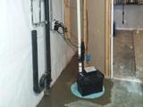 sump pump with backup battery installed in a basement