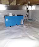 Blue dehumidifier and sump pump installed on white vapor barrier in a clean, insulated crawl space.