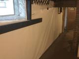 fieldstone foundation basement waterproofed with interior drainage and a wall vapor barrier