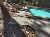 preparing to install polyurethane foam injections around a concrete pool deck