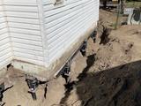 helical piers installed under foundation footer