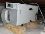 dehumidifier installed in a crawl space encapsulated with a vapor barrier