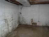 basement with wall cracks and leaking water