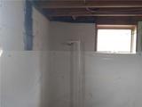 carbon fiber strap and wall vapor barrier installed in a basement