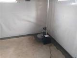 basemen waterproofed with interior drainage, a sump pump, and a wall vapor barrier