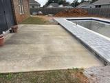 uneven concrete patio next to pool