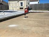 drilling small holes into sunken concrete