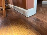 uneven floor with a gap between the floor and wall