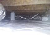Crawl space with plastic vapor barrier on the floor and insulated air ducts above.