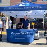 Groundworks employee standing at a company booth at a Music on Main event in Downtown Bozeman