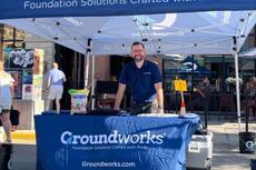 Groundworks employee standing at a company booth at a Music on Main event in Downtown Bozeman
