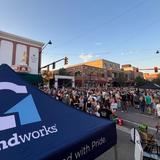 Groundworks tent in the foreground and a crowd of people in the background at a Music on Main event in Downtown Bozeman