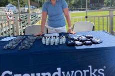 Groundworks employee at a company booth at a Harrisburg Senators game