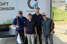four Groundworks team members holding clay shooting guns at AMX clay shoot sponsorship event