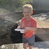 a child with a handmade boat created at Groundworks Fort Wayne's Kids' Craft Zone at the Dragon Boat Races