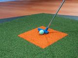 putter next to a golf ball on turf for a mini golf course