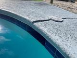 cracking and uneven concrete slabs on a pool deck