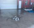 image of uneven concrete and the doorway water was entering through before Groundworks concrete leveling