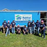 Groundworks' Central Pennsylvania team, formerly Baker's Waterproofing, standing next to a Habitat for Humanity sign during the Build Together 2023 initiative