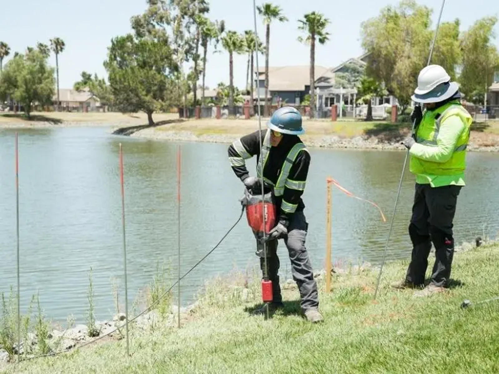 image of Groundworks employees installing grout curtain barrier through injection rods at job site
