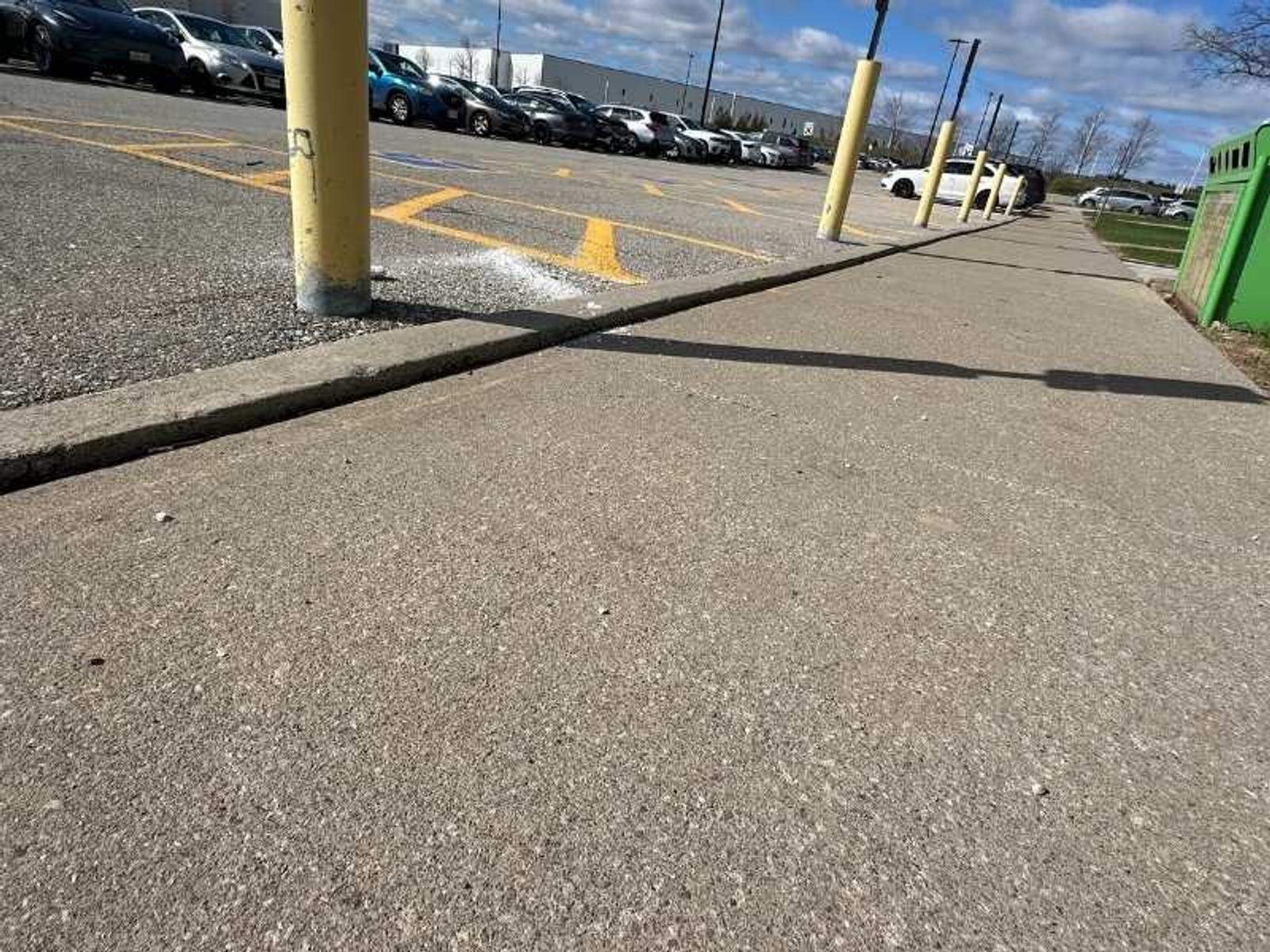image of sunken concrete trip hazards at big box store before Groundworks performed polyurethane injection concrete leveling for trip hazard repair