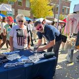 Groundworks team member and local woman at sponsorship booth at Dover's 41st Annual Apple Harvest Day 2025