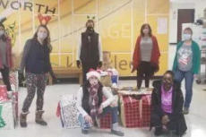 teammates from Groundworks' Pittsburgh branch, formerly Baker's Waterproofing, stand with donations made to the Bentworth School District